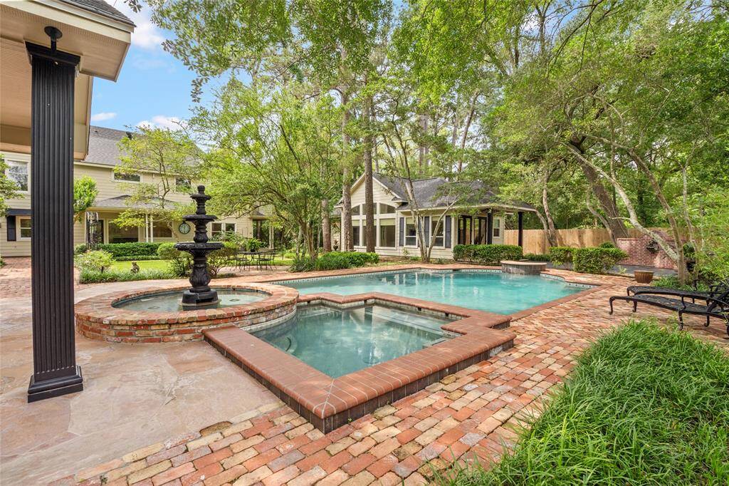 Step into a New Orleans–style backyard oasis featuring elegant fountains, rich brick and stone surfaces, guest house, and lush landscaping. This private retreat is complete with a heated saltwater pool, hot tub, and multiple outdoor living areas—perfect for relaxing or entertaining in timeless style.