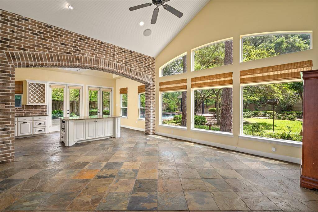 Charming guest house with slate tile flooring, a beautiful brick archway, and a full kitchen, bathroom, and laundry—ideal for guests, or extended stays.