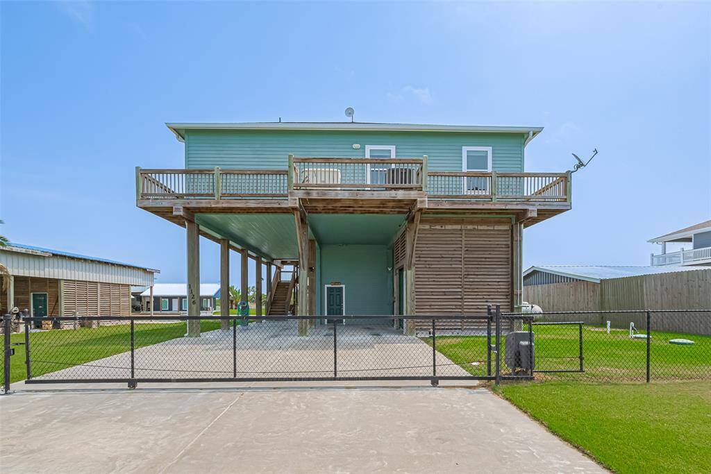 Ground level boasts a workshop / man cave, tool storage room, outside shower for cleaning up from a long day on the water or in the sun. The gate has an electric gate operator.