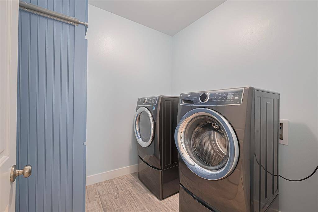 Utility room with beautiful built-ins for extra storage.