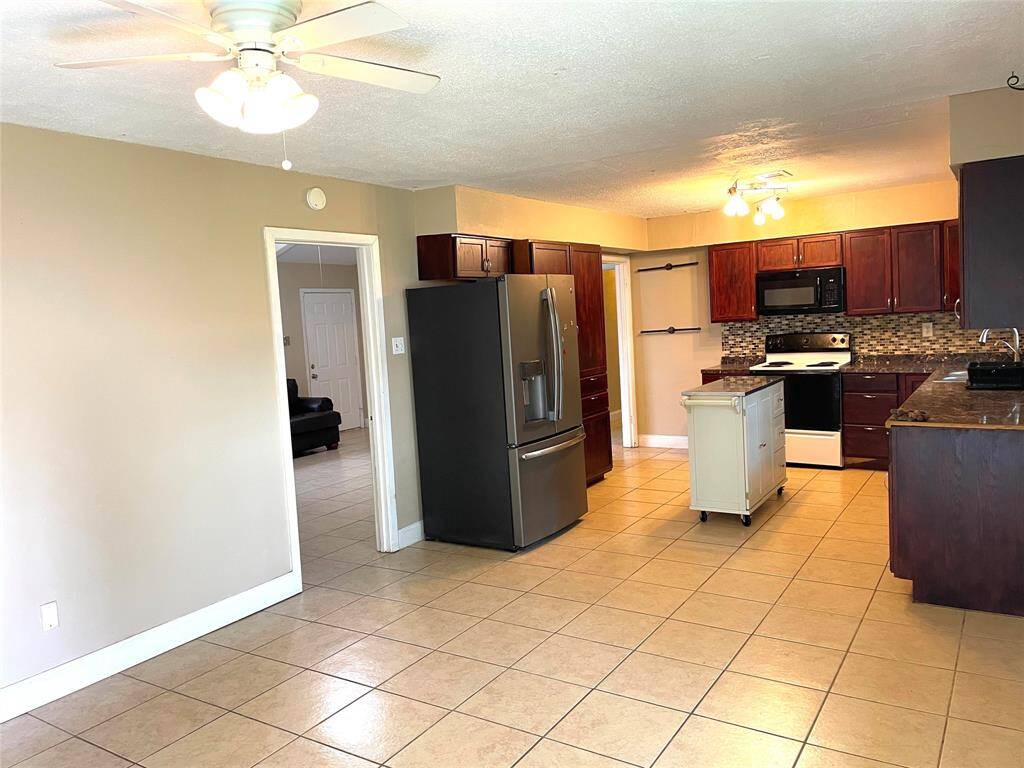 Dining and kitchen view – tile throughout and plenty of space.