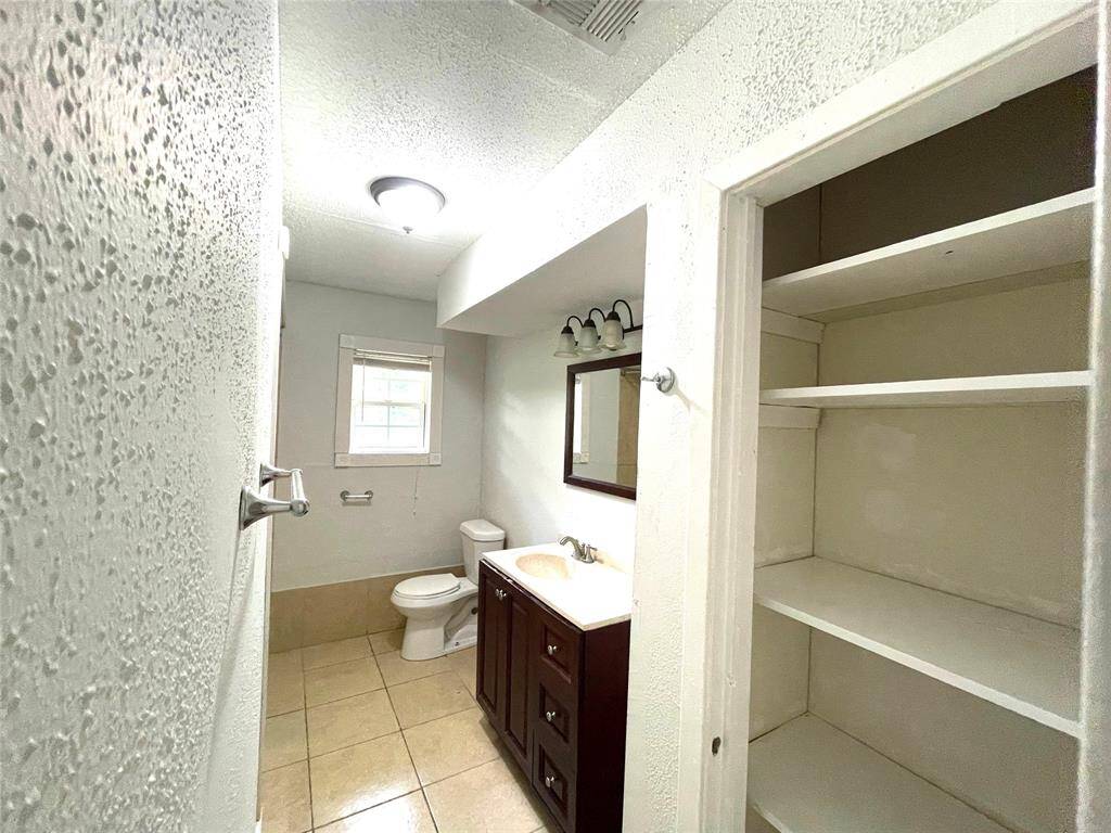 Walk-in closet with built-in shelving – abundant storage.