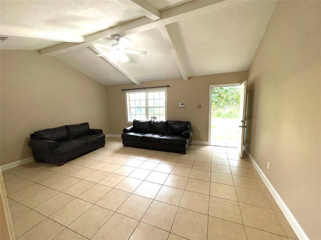 Alternate angle of the bright living room with large window views.