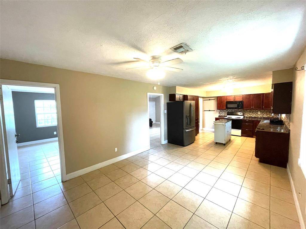Open layout showing living area leading to kitchen and hallway.