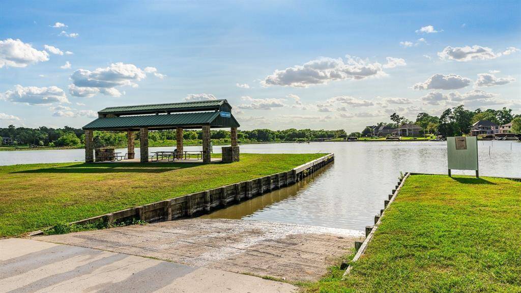 This photo presents a peaceful lakeside setting with a well-maintained picnic pavilion, offering a scenic view and a place for outdoor activities. A boat ramp provides convenient lake access.