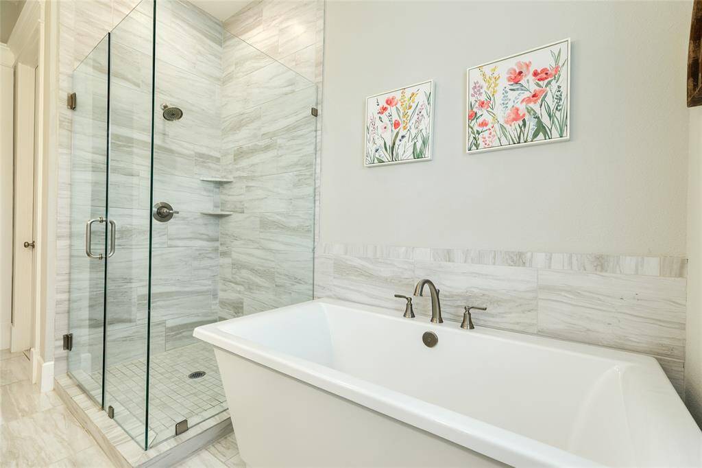 Decorative tiled walk in shower and soaking tub.