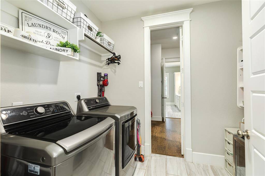 Laundry room with access to primary bedroom closet and kitchen access.