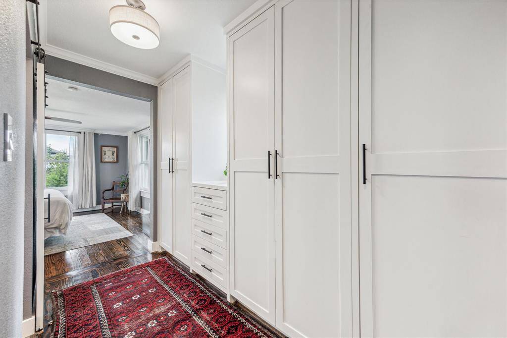 Custom built-in closets and drawers line the hall from the ensuite bath to the bedroom.