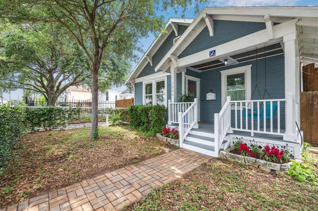 Inviting front porch is the perfect space to sit and enjoy watching your loved ones play in the fully fenced front yard.