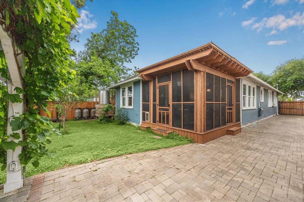 An electric driveway gate opens to a long private drive, complete with an EV charging station.