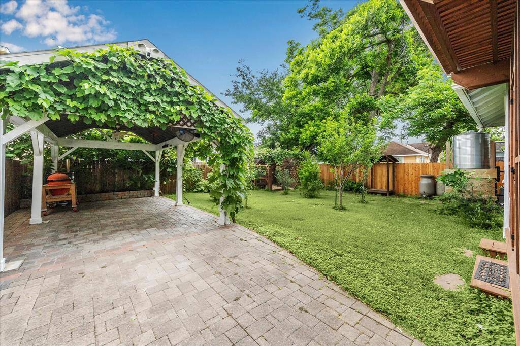 View of the gorgeous carport covered with grape leaves.