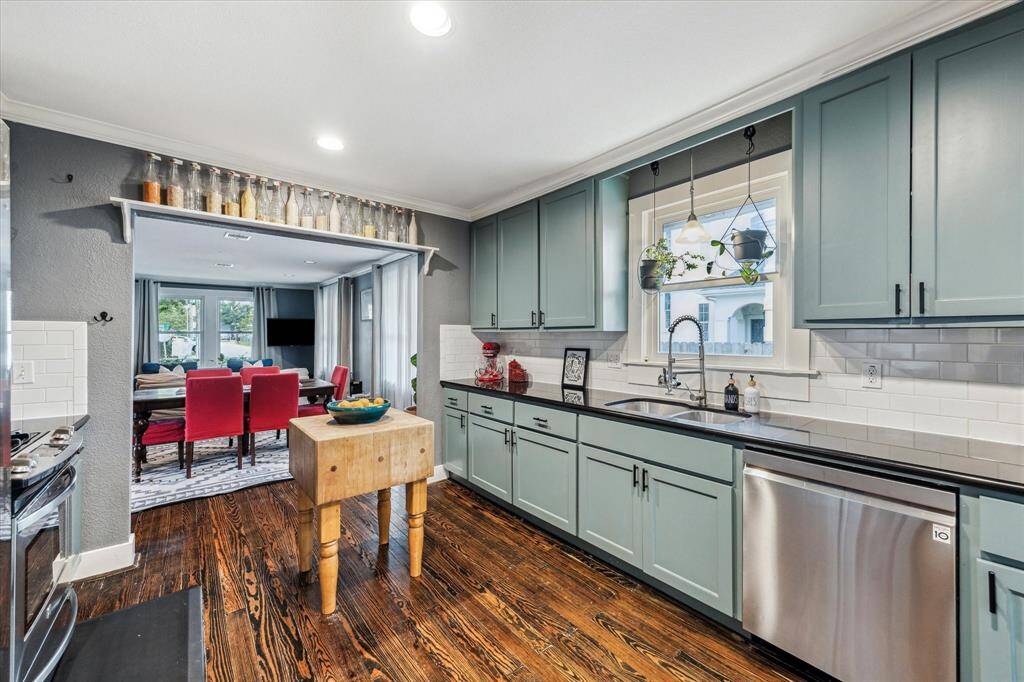 The kitchen is a cook’s dream with granite counters, a tile backsplash, gas range and stainless-steel appliances.