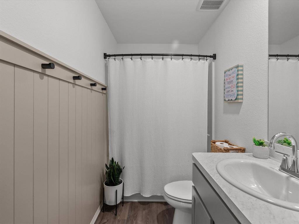 Secondary bathroom with custom board and batten towel hooks