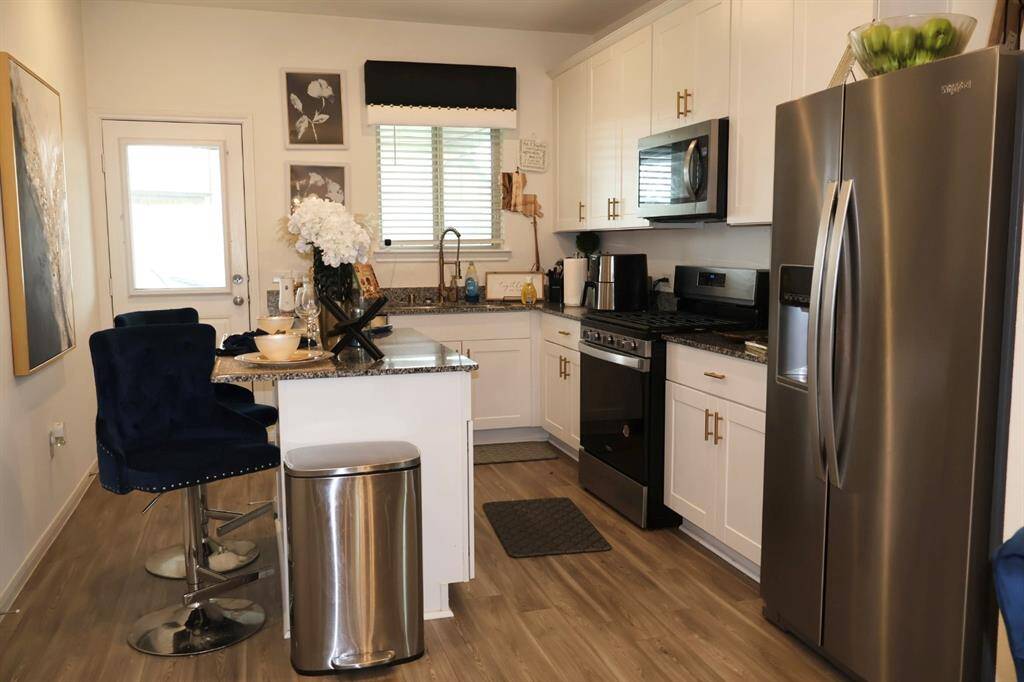 Prepare to be captivated by this home's immaculate island kitchen! Featuring stunning granite countertops, warm-colored cabinets enhanced by elegant under-cabinet lighting, a stylish subway tile backsplash, and gleaming stainless steel appliances, this kitchen is a chef's dream and a perfect gathering space.