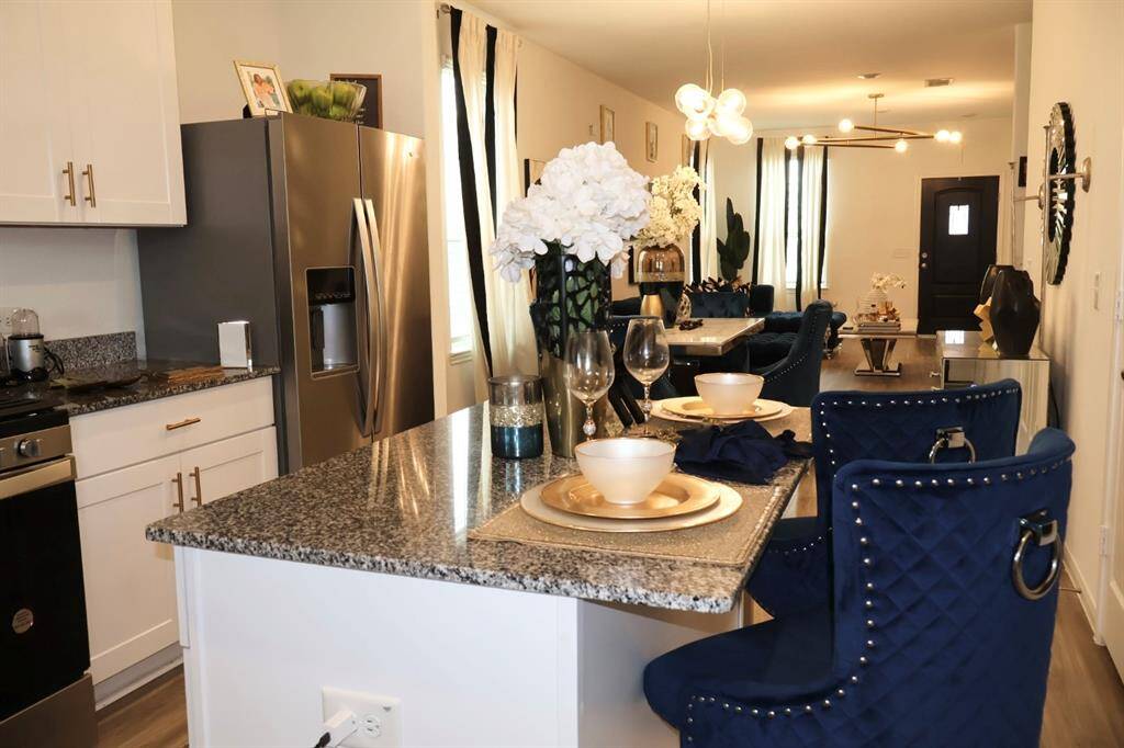 Island allows for additional seating, storage and prep space.
