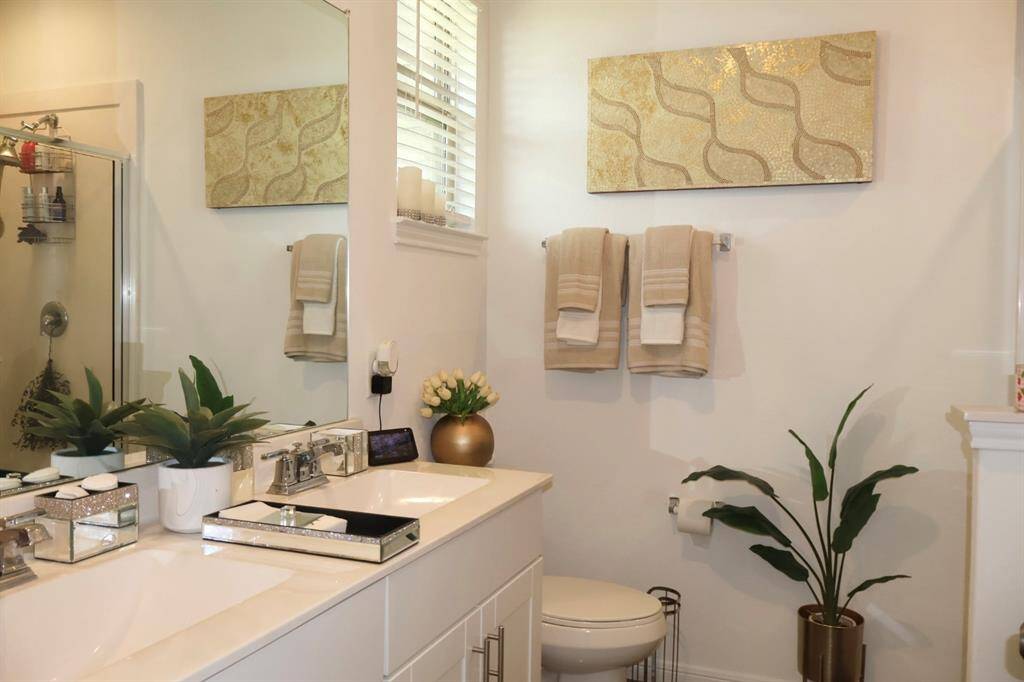 Indulge in the ultimate relaxation in your spa-like ensuite bathroom. Featuring an extended vanity with dual sinks, a stunning granite countertop, and ample storage, this space is designed for both luxury and convenience.