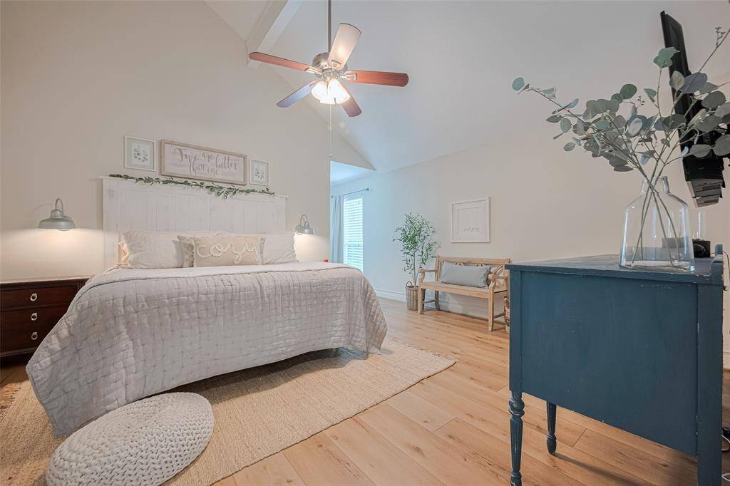 The primary bedroom features luxury vinyl plank floors, crisp white paint and modern finishes