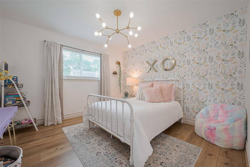 The third bedroom features luxury vinyl plank flooring, modern light fixture and a spacious closet.