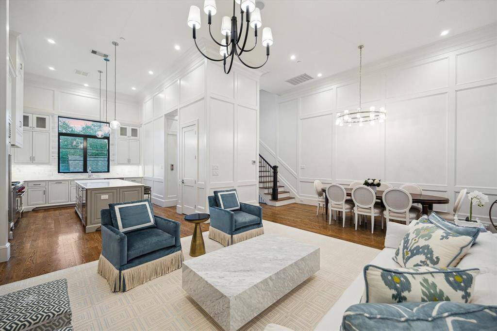 The second-floor living and dining areas seamlessly merge functionality with elegance, creating a sophisticated open-concept space designed for both comfort and style.