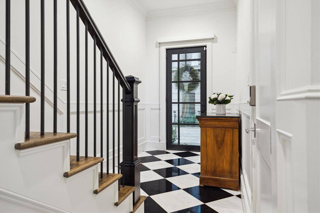 The foyer with stunning 18” Marble tile floors laid in a black and white checkerboard pattern and with elevator access to all floors.