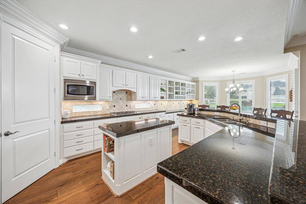 The fantastic kitchen features a spacious island and an array of premium upgrades, including full-extension drawers and pull-out sliders, offering both style and functionality for everyday living.