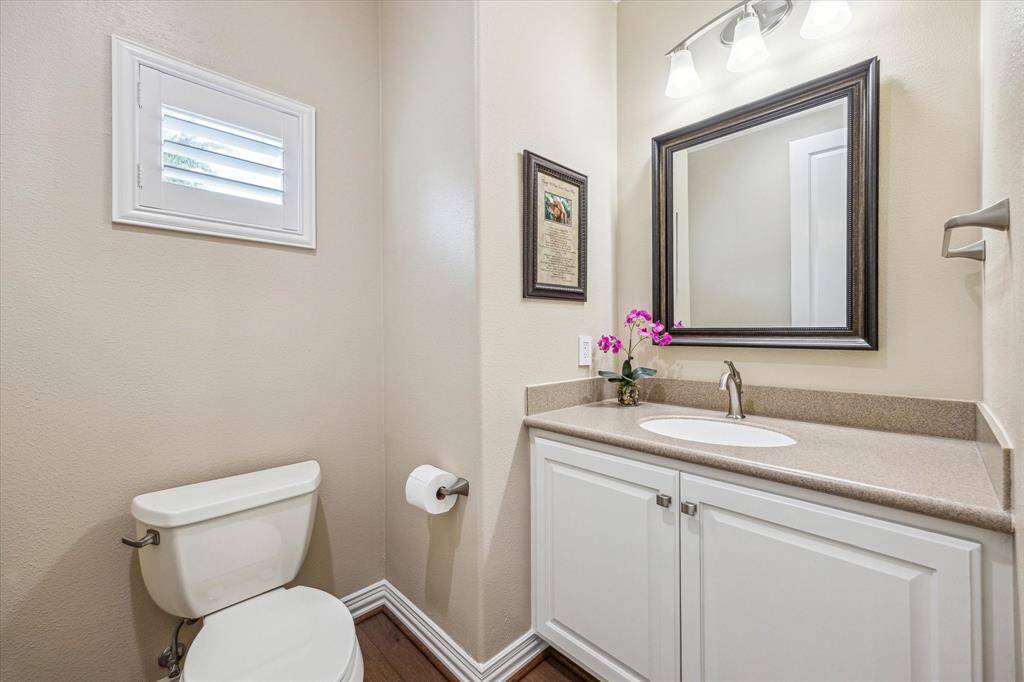 A convenient half bath is thoughtfully located for guests, with easy access from the main living areas.