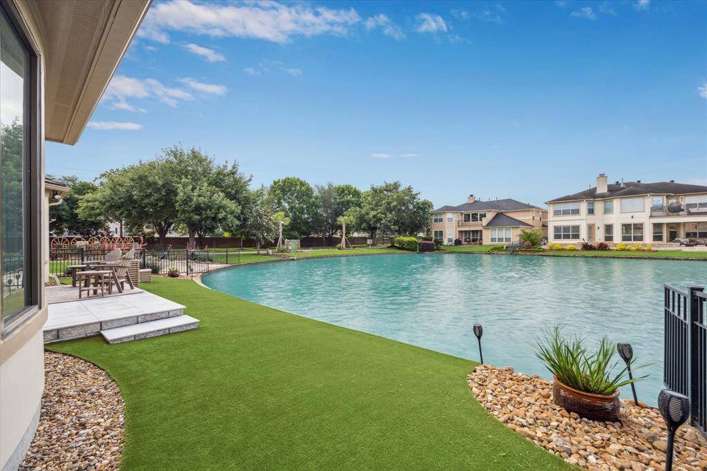 The backyard is enhanced with durable nylon turf and low-maintenance landscaping, offering both beauty and convenience.