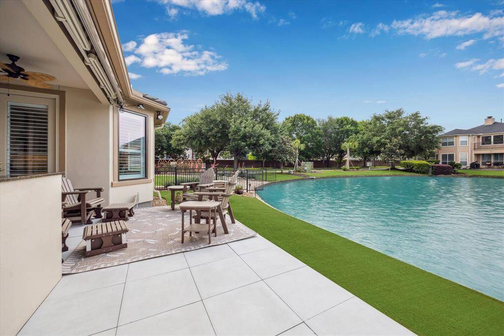 This stunning porcelain paver patio overlooks the lake, offering a wonderful space for both relaxing and dining al fresco.