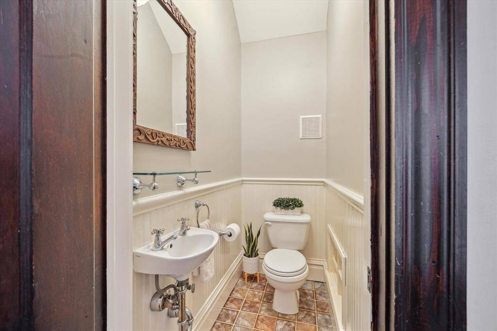 This charming powder room is tucked beneath the stairs in the hallway.