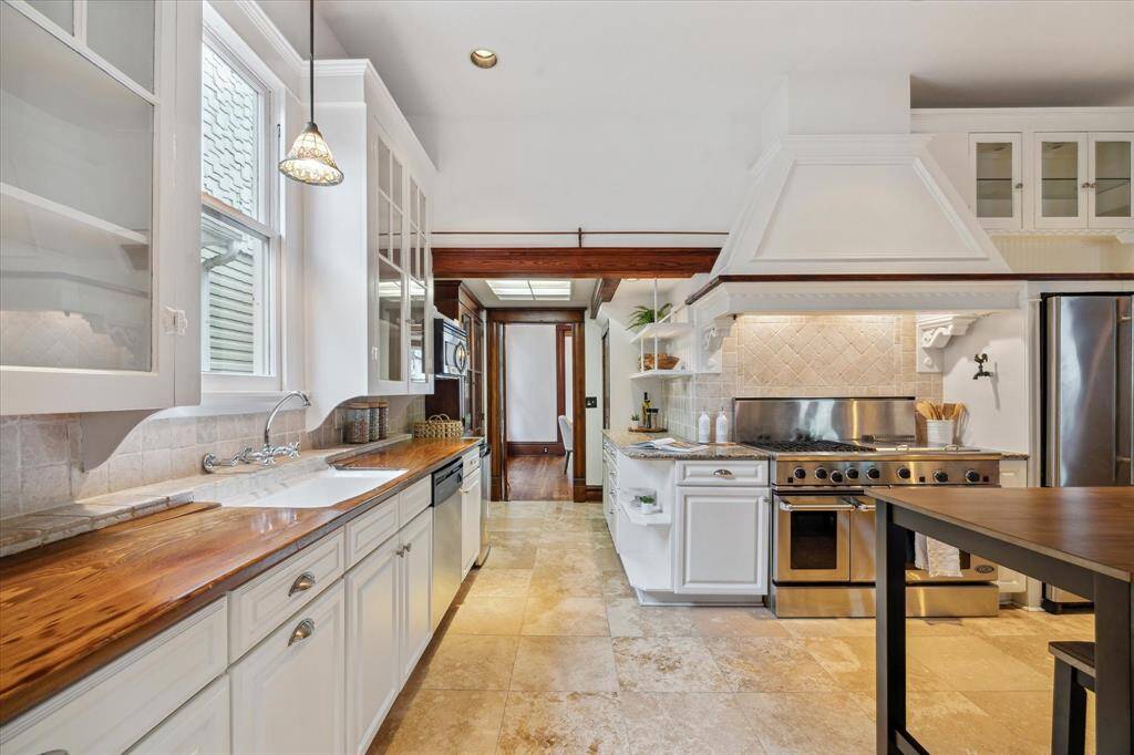 Between the kitchen and dining room, a charming pass-through features a built-in cabinet for dishware and a pantry for storage.