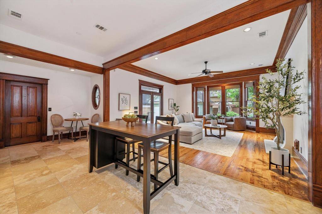 The expansive family room is filled with natural light and offers a beautiful view of the backyard, creating a bright and welcoming gathering space.  The door to the left leads to laundry area and back entrance