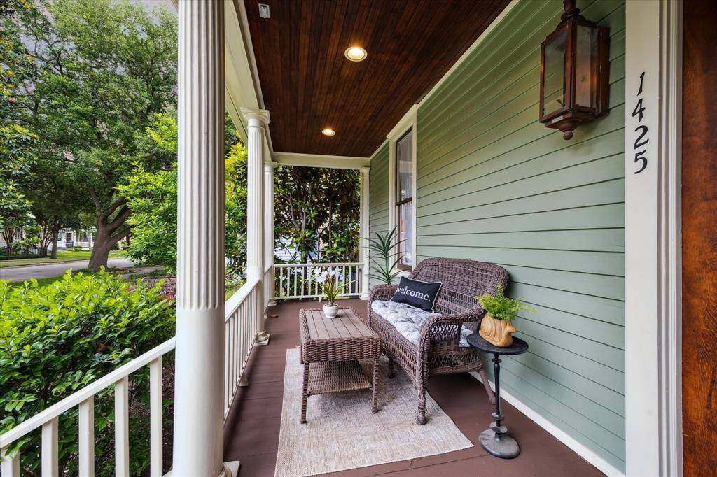 A classic front porch with beadboard ceiling and gas lantern - perfect for morning coffee or evening chats
