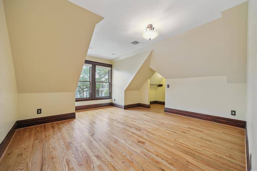 Tucked under the rooflines, this spacious secondary bedroom overlooks the front yard.