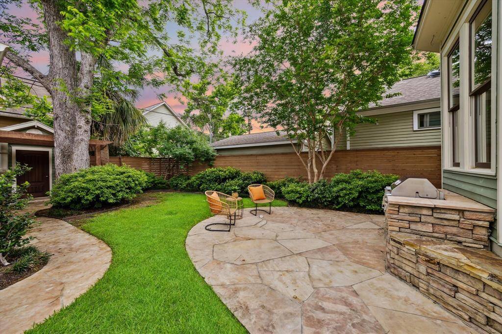 Lush landscaping and mature trees surround this tranquil flagstone patio, complete with built in grill.  Ideal for outdoor dining or quiet evenings under the sky.