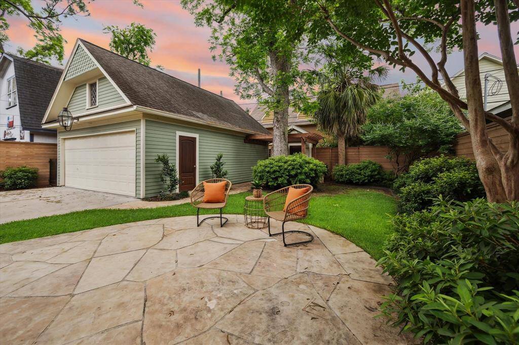 Detached two-car garage with charming architectural detail, a storage loft above and a classic gas lantern.