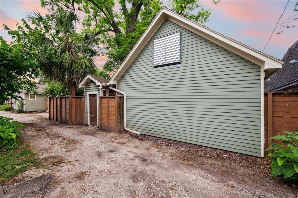 Gravel alley access behind the garage offers potential for rear garage entry, allowing flexibility, in layout and the option to expand front area for a future pool or green space.