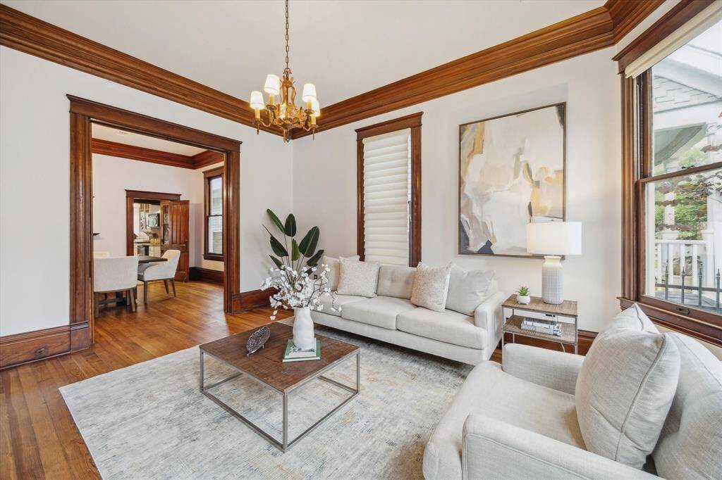 From the front living room, a wide cased opening leads to the dining room and kitchen.