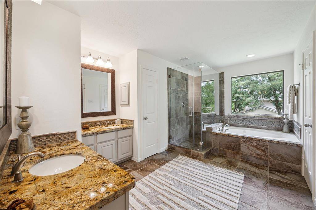 Two vanities and tiled shower