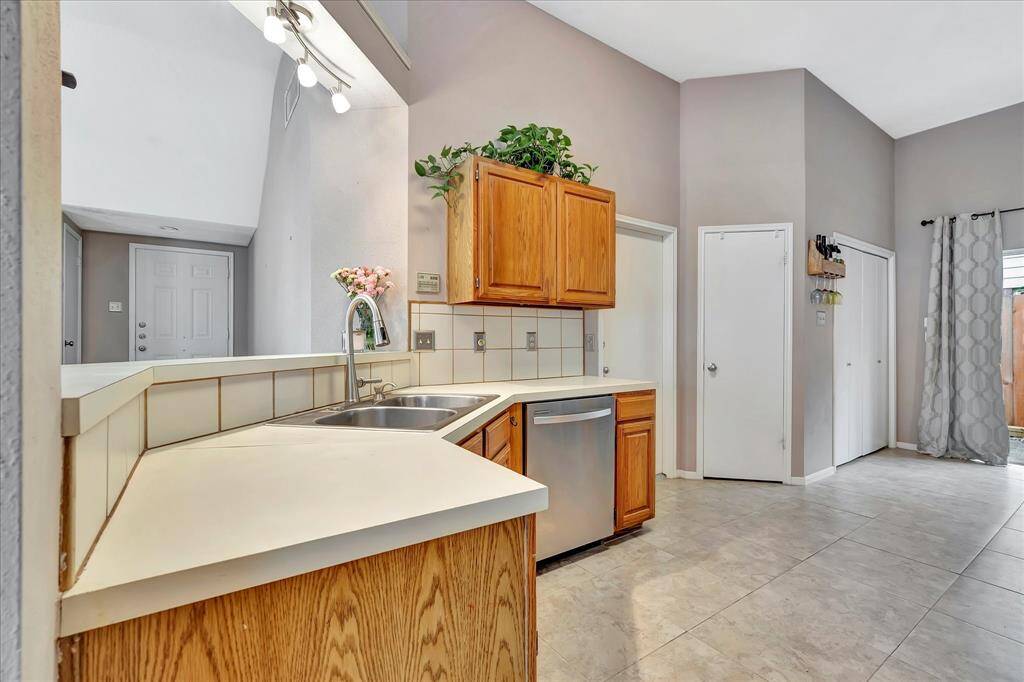 Door to the right of the cabinets leads to garage.