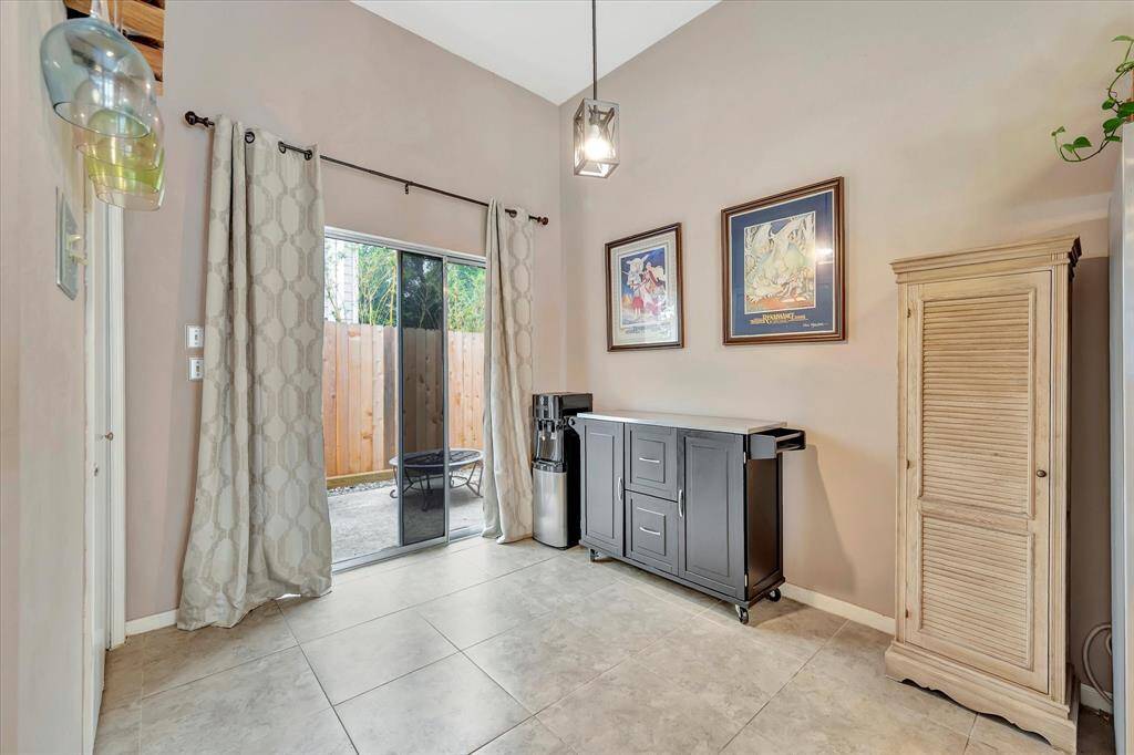 Sliding glass door to patio. Doggie door (behind curtains) can stay or be removed.