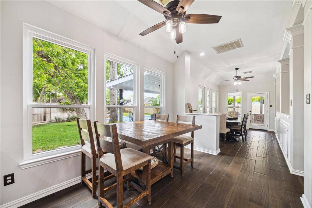 BRIGHT BREAKFAST NOOK WITH LARGE NEW WINDOWS AND BACKYARD STUNNNING BACKYARD VIEWS WITH EASY ACCESS TO THE DINING ROOM.