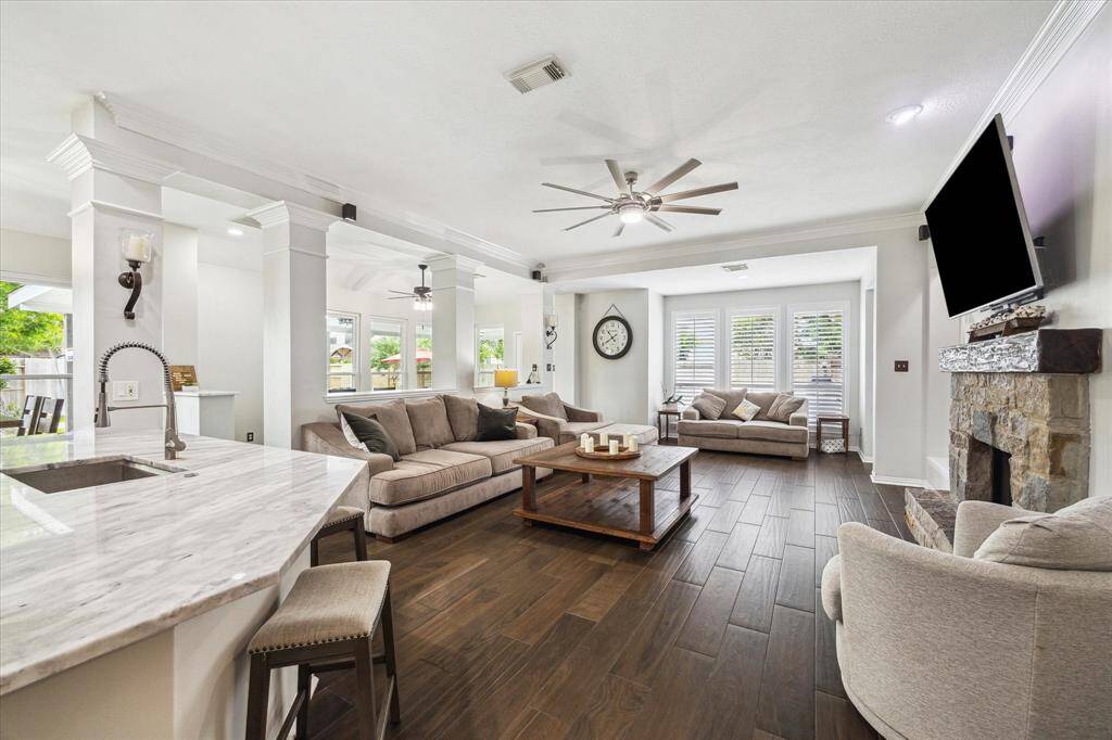 STYLISH FAMILY ROOM WITH NEW INTERIOR PAINT (2024), COZY FIREPLACE, AND CUSTOM BUILT-IN SHELVING.