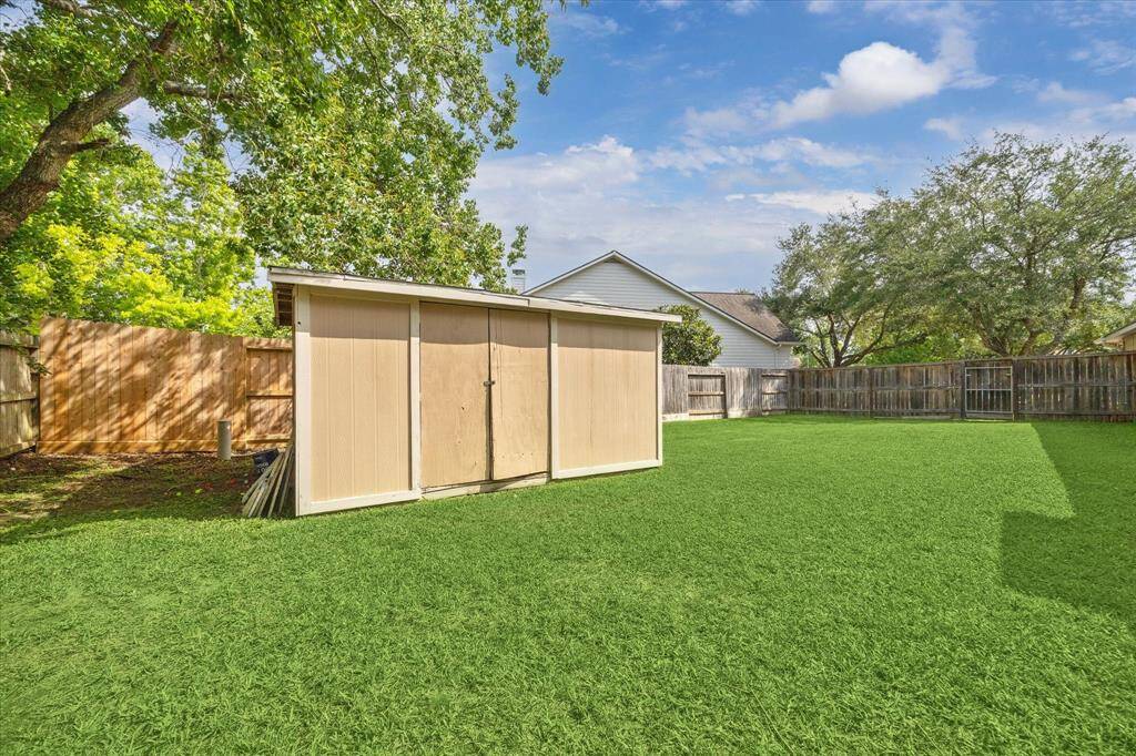 HUGE SIDE YARD WITH NEW FENCING (2024) AND STORAGE SHED—IDEAL FOR HOBBIES, GARDENING, OR PLAY SPACE.