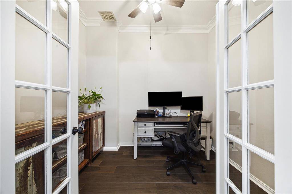 LIGHT-FILLED PRIVATE STUDY WITH FRENCH DOORS, CROWN MOLDING, AND GORGEOUS FLOORING.