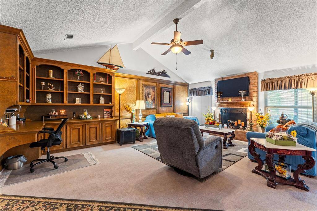 Amazing Living Room with High Ceilings, a nice Fireplace, and beautiful Built-in workspace!