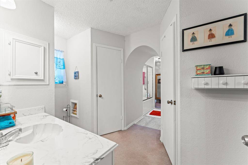 Primary Bath was customized with an arch entryway into a beautiful  area with a Vanity.