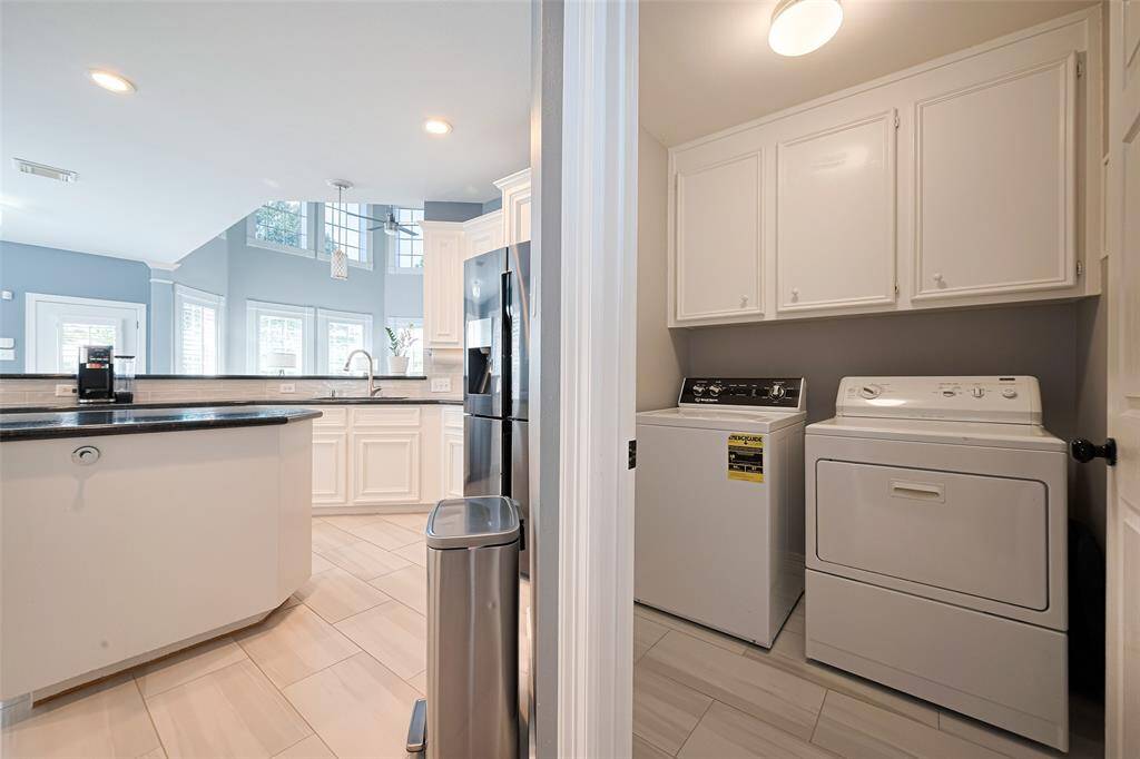 The laundry room is located off the kitchen.