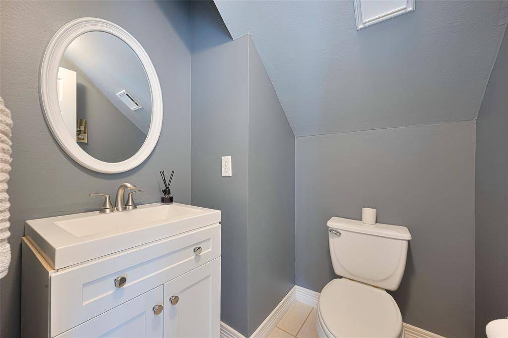 The downstairs half-bath has been updated with a single modern vanity & fresh paint.