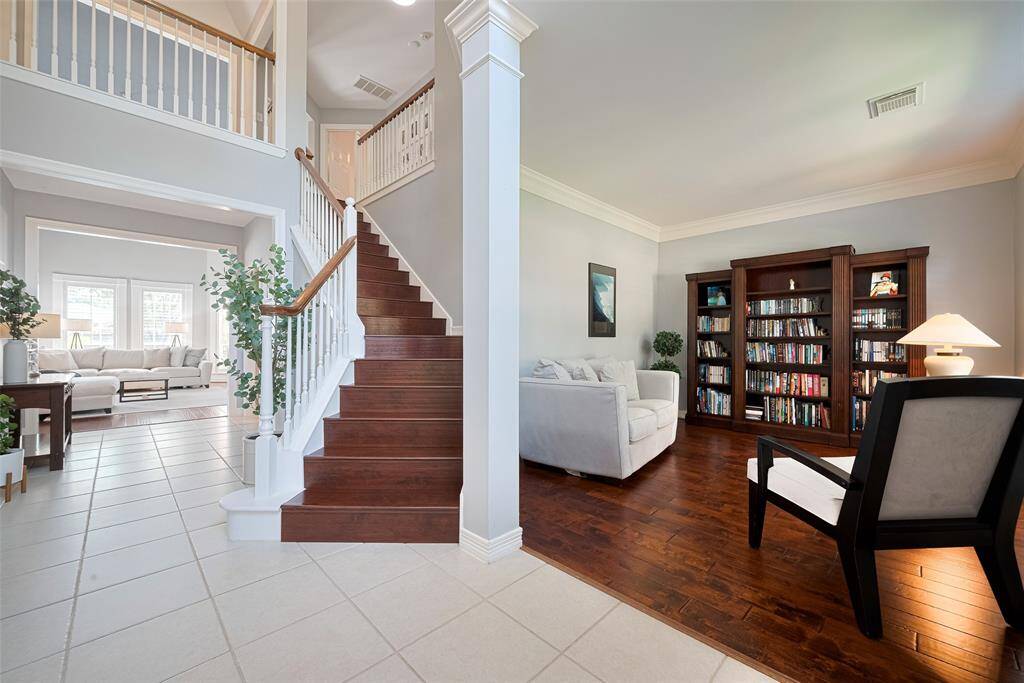 Grand entryway is bright and welcoming.  Formal living could also be a formal dining room.