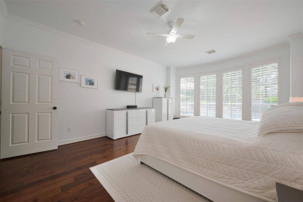 The primary bedroom offers lovely views of the backyard.
